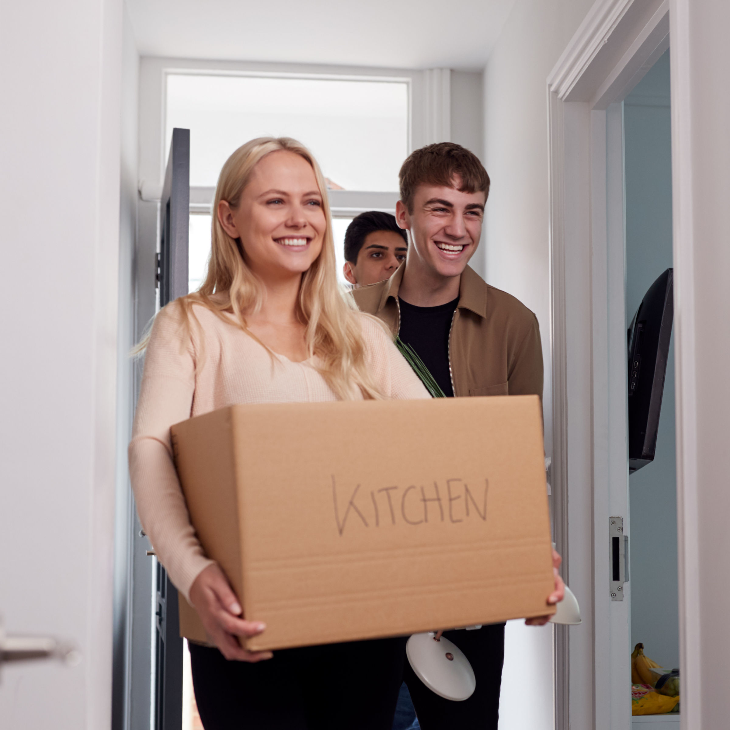 college students carrying boxes